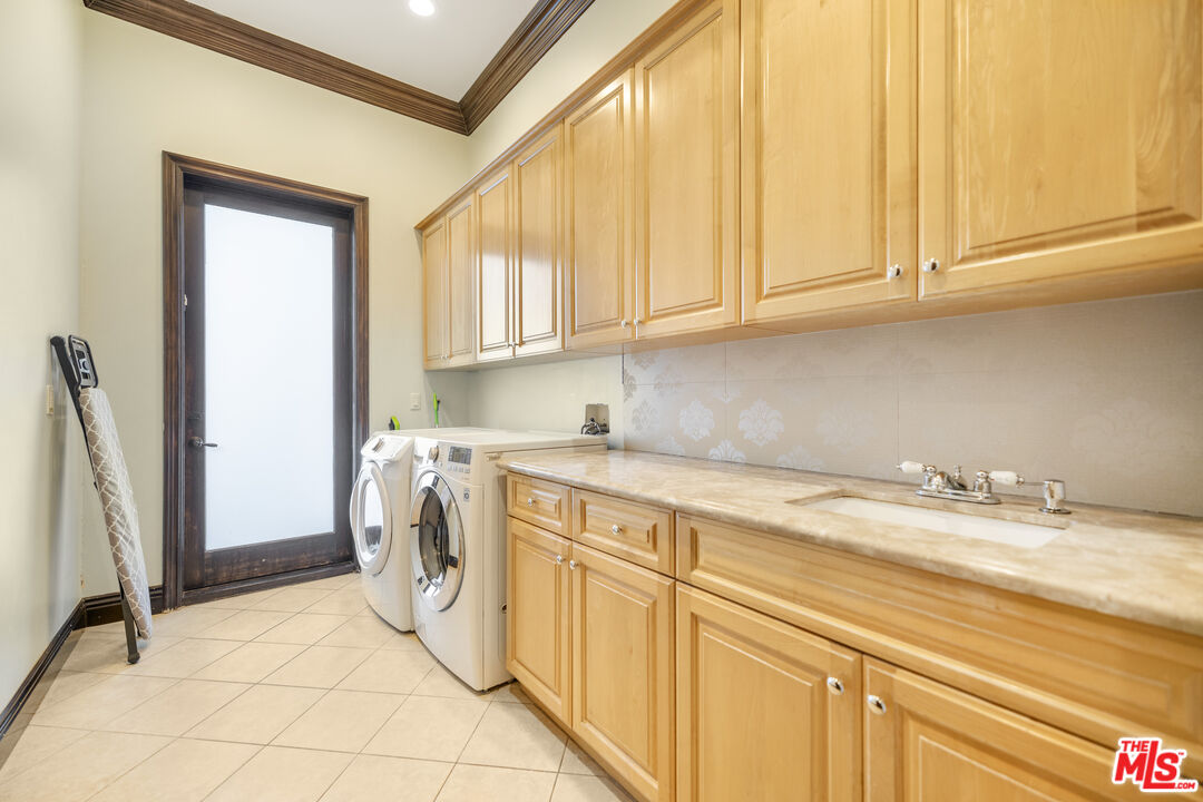 18607 Cassandra Street Tarzana, CA 91356 - Photo 48 of 58 a utility room with a sink washer and dryer