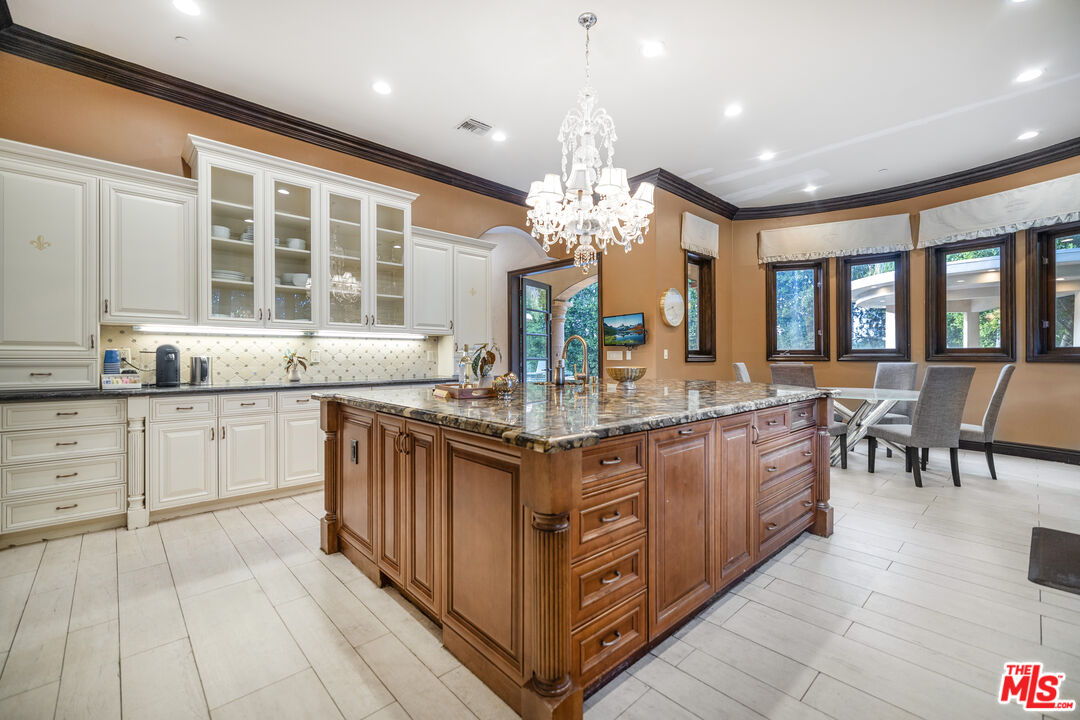 18607 Cassandra Street Tarzana, CA 91356 - Photo 5 of 58 a kitchen with granite countertop a sink stove and cabinets