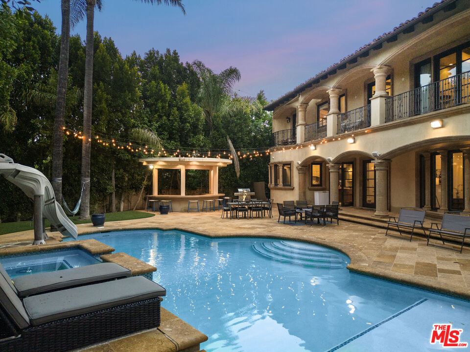 18607 Cassandra Street Tarzana, CA 91356 - Photo 55 of 58 a view of a swimming pool with chairs and tables