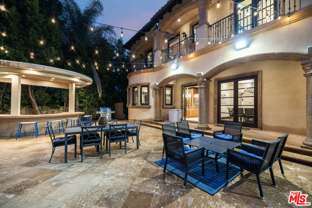 18607 Cassandra Street Tarzana, CA 91356 - Photo 56 of 58 a living room with patio furniture and a large tree