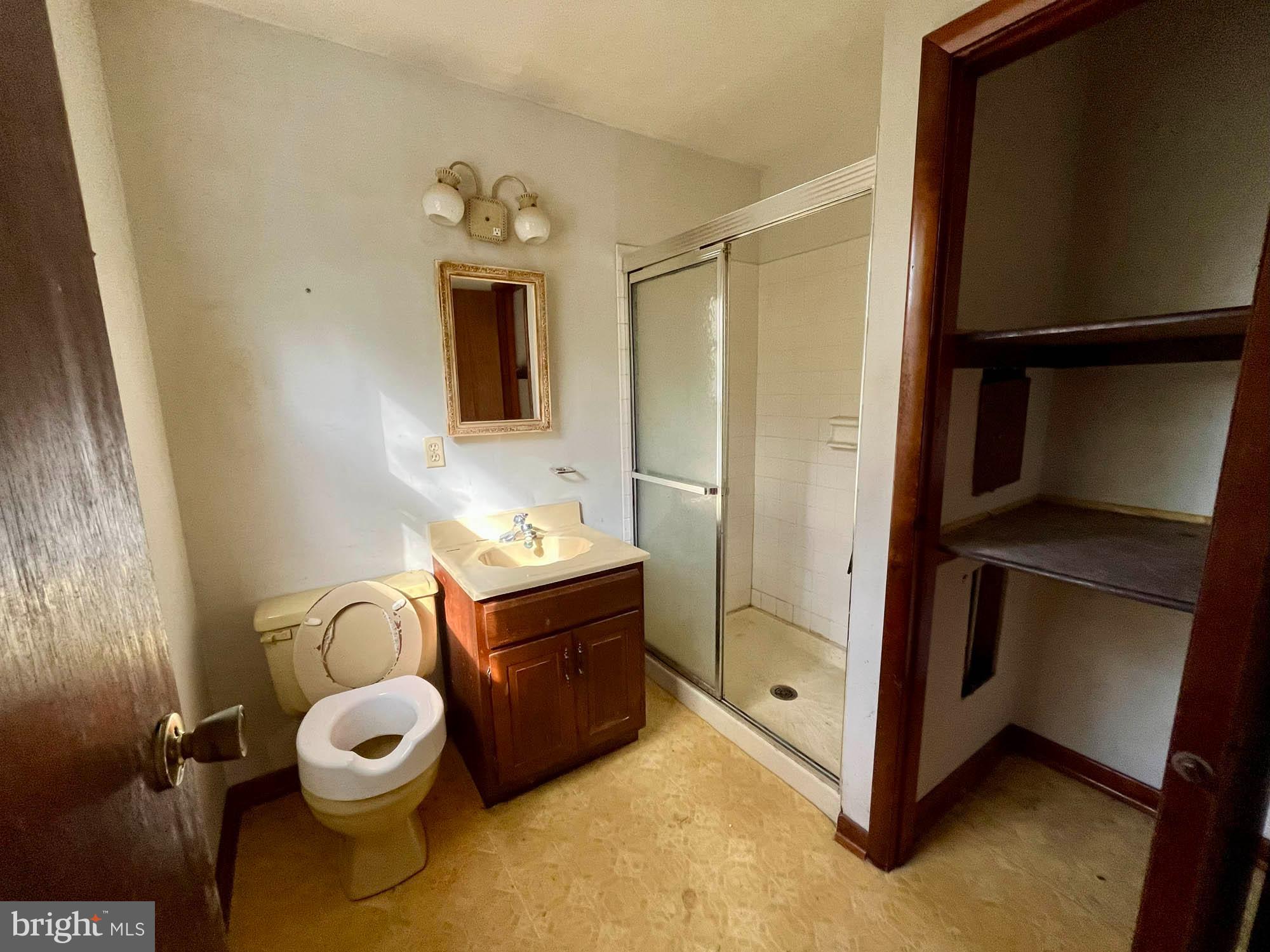 4992 Millers Station Road Hampstead, MD 21074 - Photo 12 of 24 a bathroom with a toilet sink and mirror