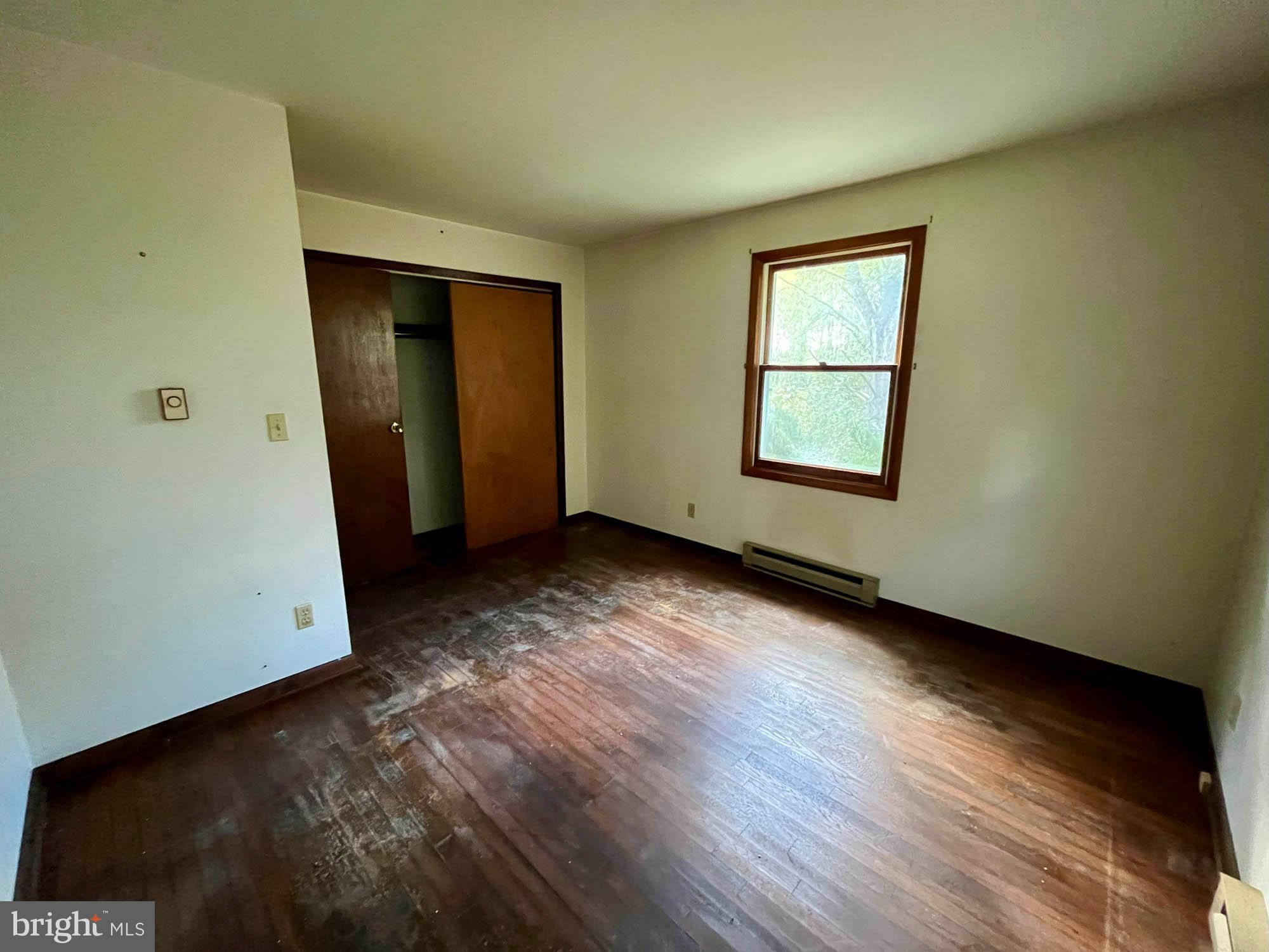 4992 Millers Station Road Hampstead, MD 21074 - Photo 14 of 24 a view of an empty room with wooden floor and a window