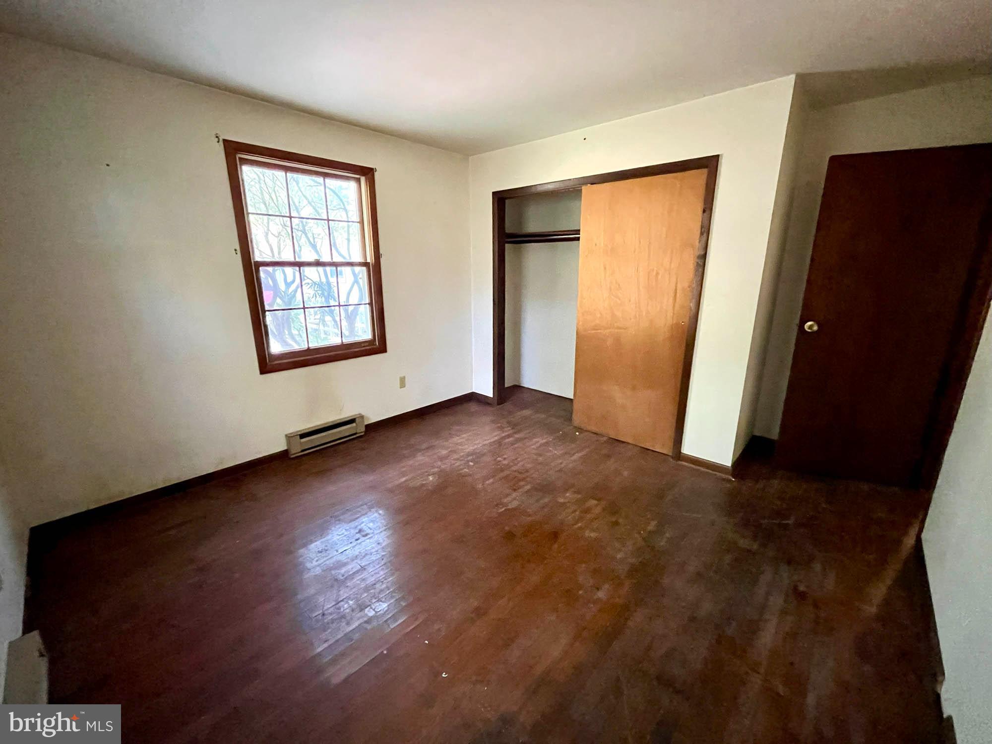4992 Millers Station Road Hampstead, MD 21074 - Photo 15 of 24 an empty room with wooden floor and windows