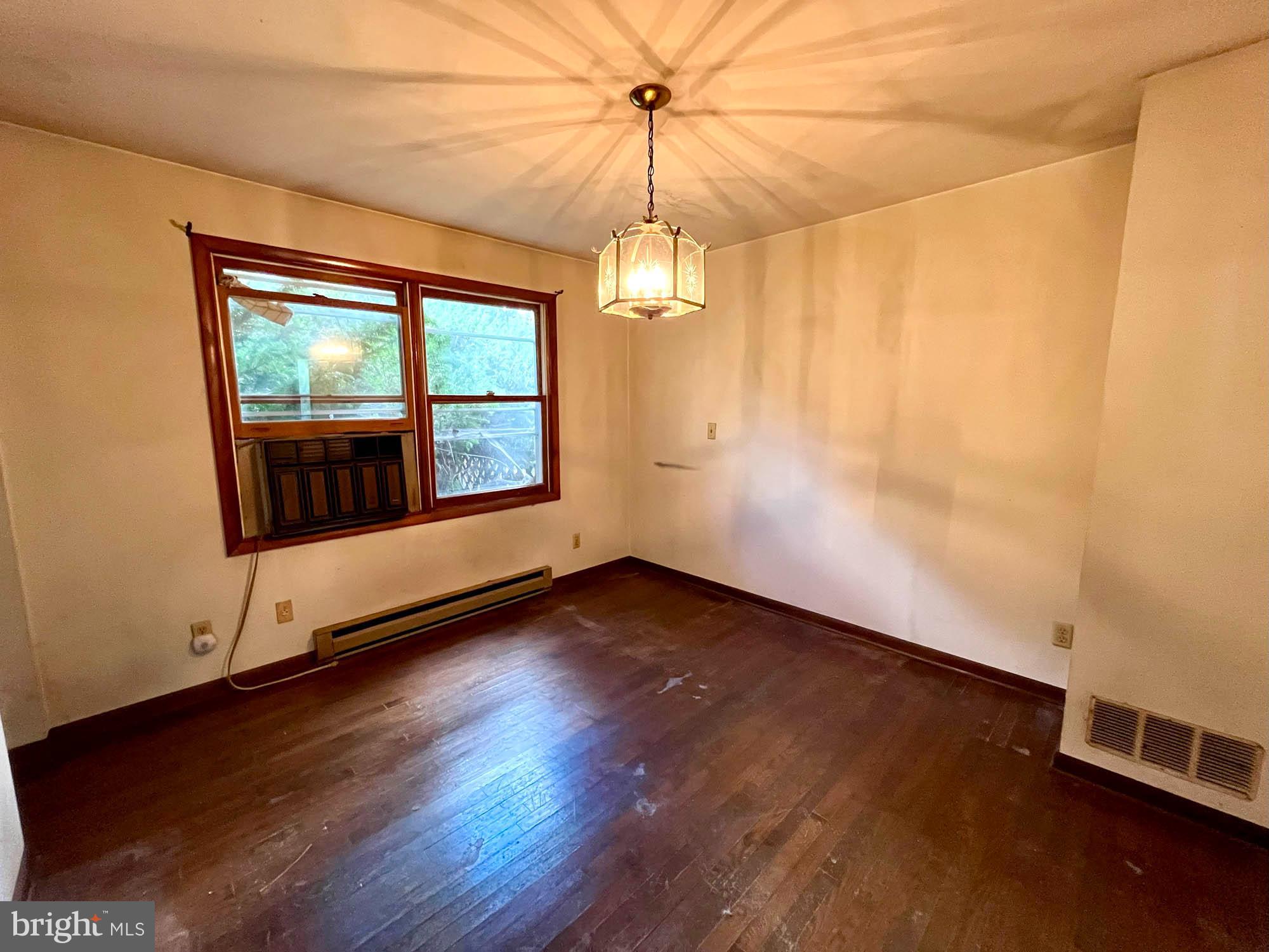 4992 Millers Station Road Hampstead, MD 21074 - Photo 10 of 24 an empty room with wooden floor and windows