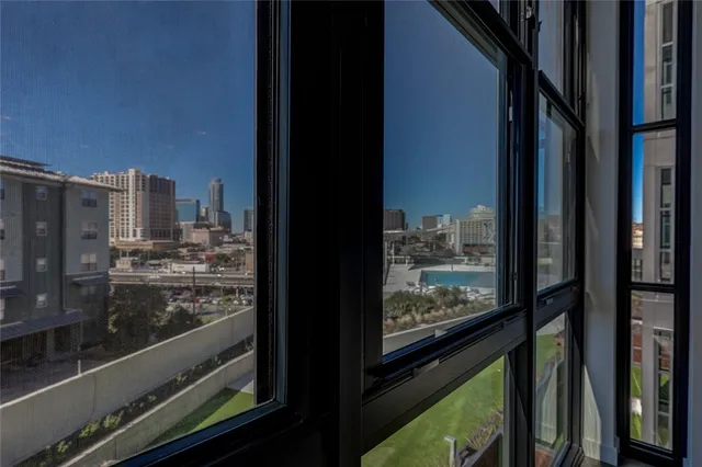 a view of a kitchen with wooden floor and a window