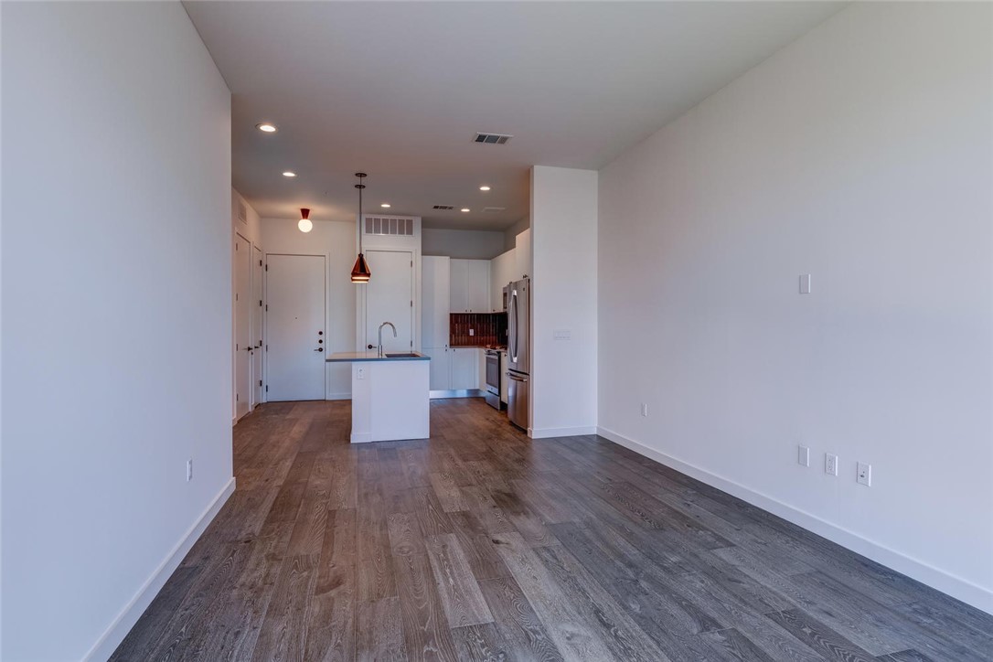 800 Embassy Drive, Unit 233 Austin, TX 78702 - Photo 14 of 40 a view of a kitchen with wooden floor and a window
