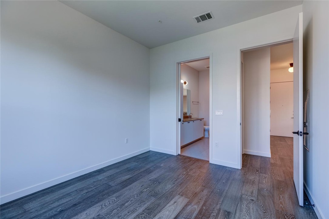 800 Embassy Drive, Unit 233 Austin, TX 78702 - Photo 16 of 40 a view of a livingroom with wooden floor and a bathroom