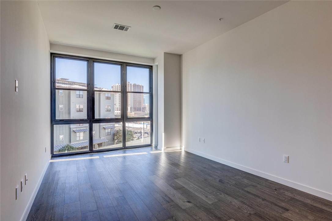 800 Embassy Drive, Unit 233 Austin, TX 78702 - Photo 2 of 40 wooden floor in an empty room with a window