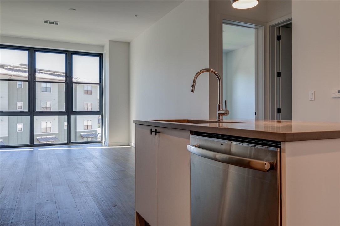 800 Embassy Drive, Unit 233 Austin, TX 78702 - Photo 29 of 40 a view of a kitchen from a hallway