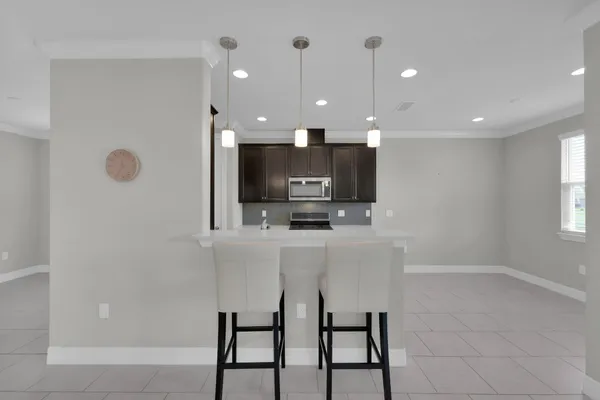 a kitchen with stainless steel appliances granite countertop a sink a stove and a refrigerator