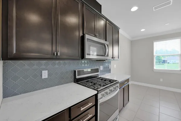 a kitchen with a sink chandelier and window