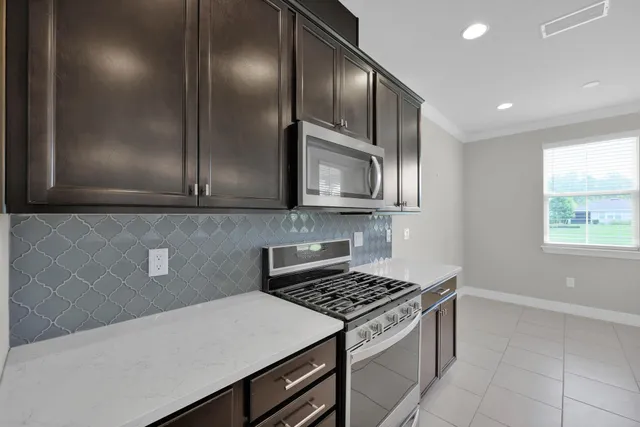 a kitchen with a sink chandelier and window