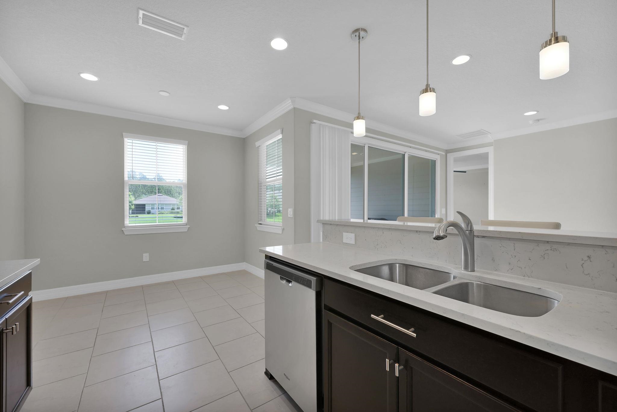 164 Front Door Lane St. Augustine, FL 32095 - Photo 18 of 42 a kitchen with a sink chandelier and window