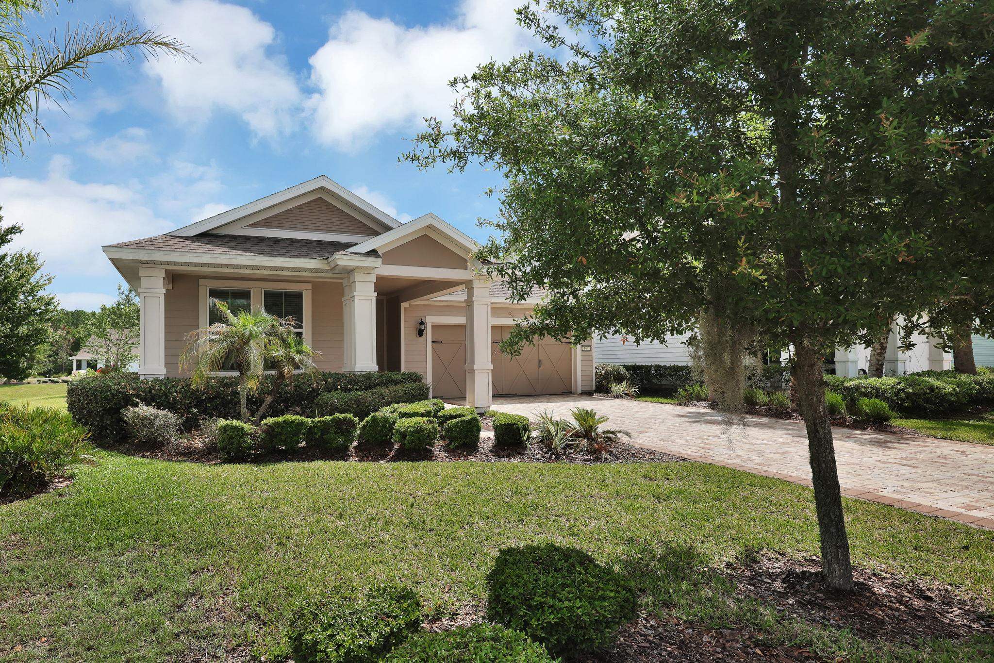 164 Front Door Lane St. Augustine, FL 32095 - Photo 2 of 42 a front view of a house with garden