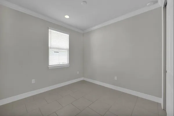 a view of an empty room with a ceiling fan