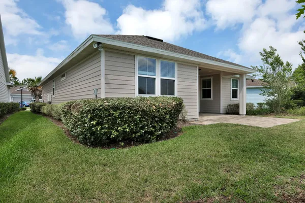 a front view of house with yard and green space