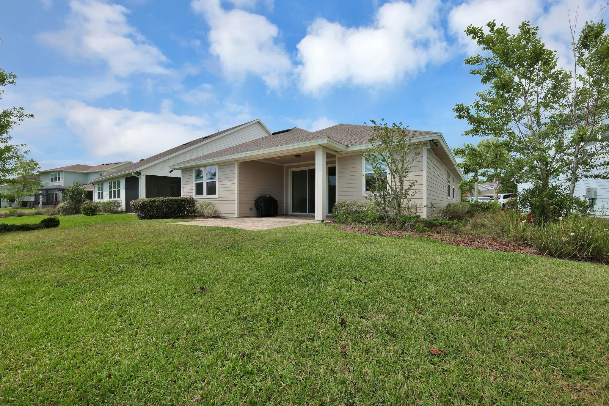 164 Front Door Lane St. Augustine, FL 32095 - Photo 31 of 42 a front view of house with yard and green space