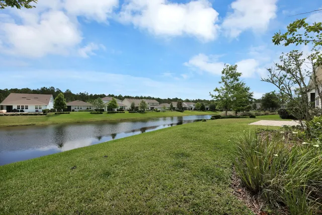an aerial view of residential houses with outdoor space and swimming pool