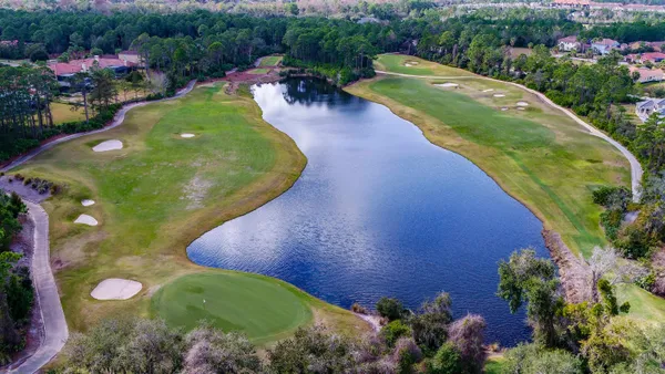 an aerial view of a house with a swimming pool yard and outdoor seating
