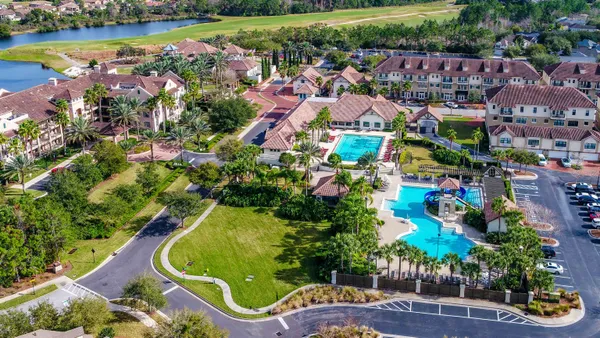 an aerial view of multiple houses with yard