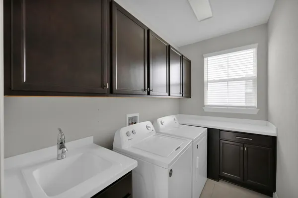 a kitchen with kitchen island stainless steel appliances a sink stove and cabinets
