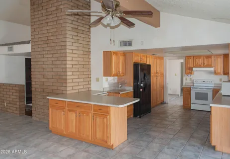 a kitchen with stainless steel appliances granite countertop a sink a stove and a refrigerator