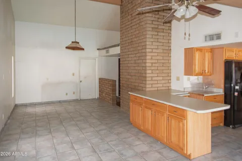 a view of a hallway with wooden floor and a living room