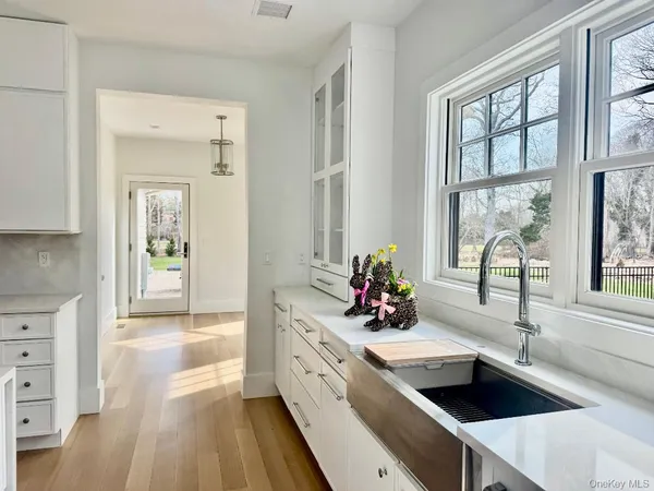 a spacious bedroom with a bed a couch and a flat tv screen on the table