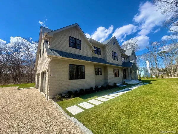 a view of empty room with wooden floor and furniture