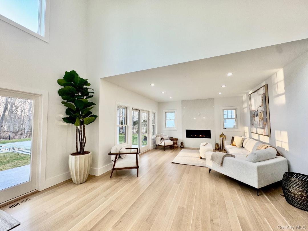 69 Jagger Lane Westhampton, NY 11977 - Photo 22 of 50 Living area featuring plenty of natural light, light wood flooring, a fireplace, and recessed lighting