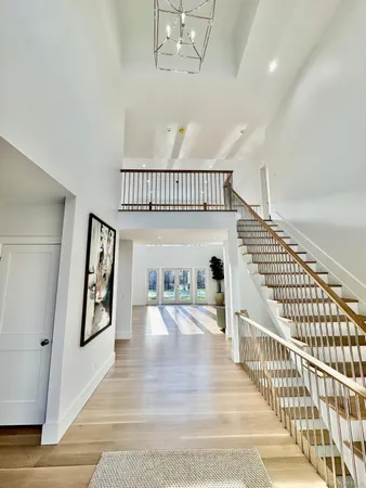a view of a room with wooden floor and windows