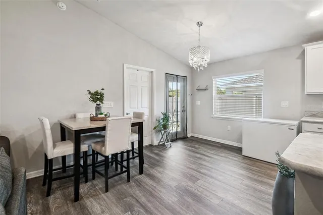 a large white kitchen with a large window and stainless steel appliances