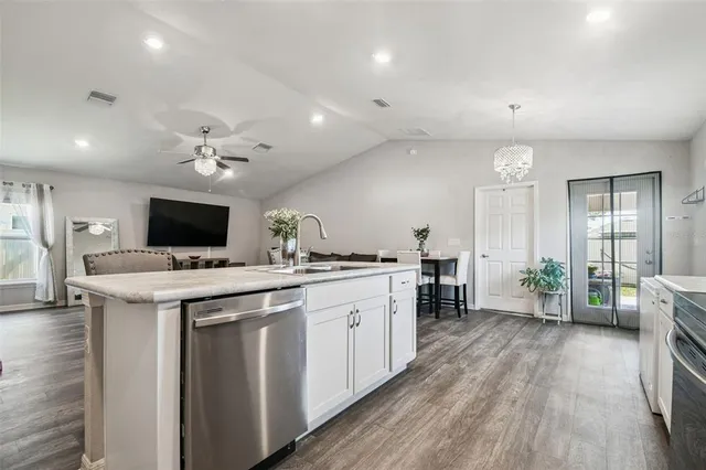 a view of a hallway with wooden floor and a bathroom