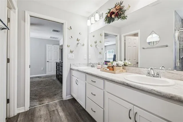 a bathroom with a sink a toilet and mirror