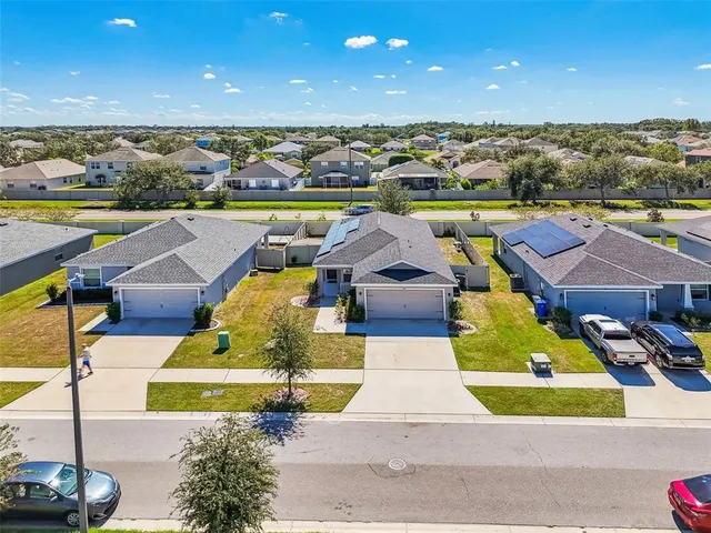 a view of swimming pool with outdoor seating and plants