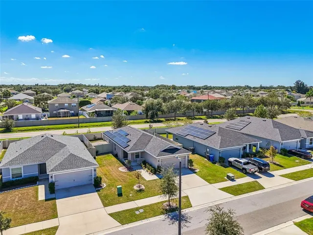 a view of a swimming pool with a yard and sitting area