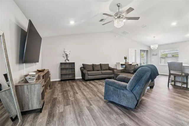 a living room with furniture and a chandelier