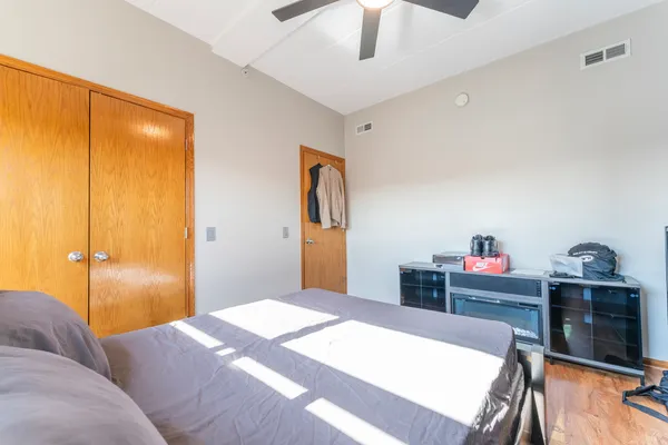 a bedroom with a bed and a chandelier