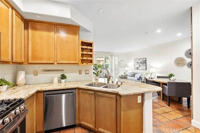 a kitchen with a sink a stove cabinets and wooden floor