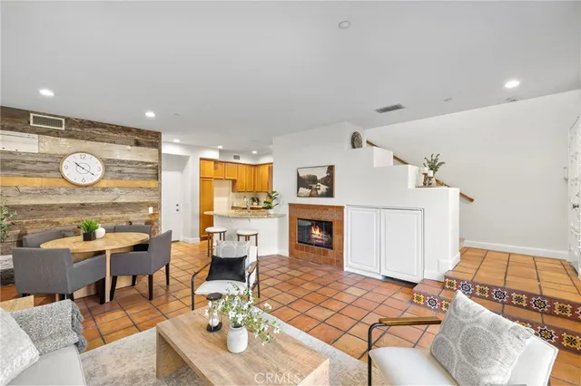 a living room with furniture a fireplace and a table