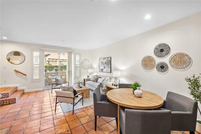 a living room with furniture and a floor to ceiling window