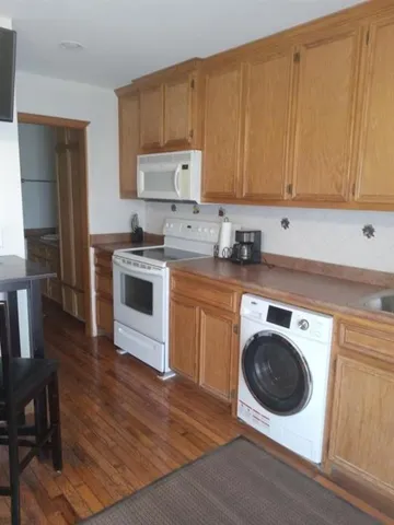 a kitchen with a stove top oven sink and cabinets