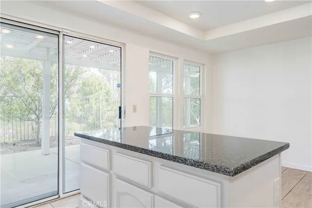 a kitchen with granite countertop a sink and a large window