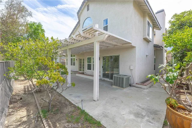 front view of a house with a chairs and table in a patio
