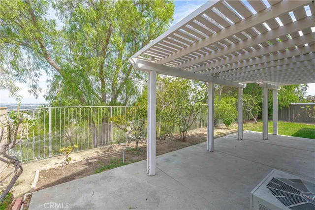 a view of a house with a backyard and a patio