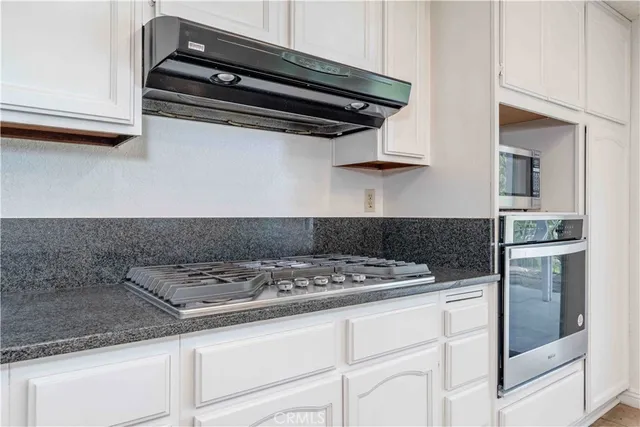 a close view of a stove a microwave and cabinets in the kitchen