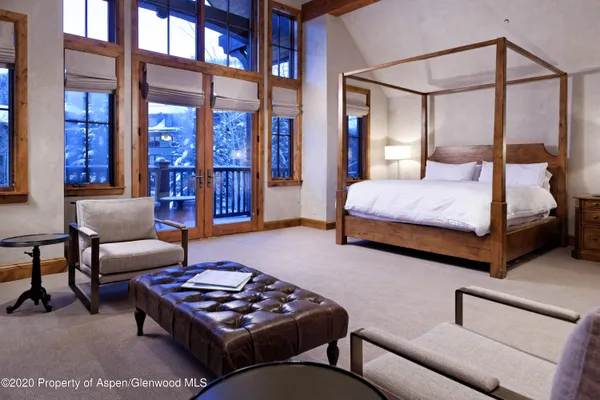 a bedroom with furniture and wooden floor