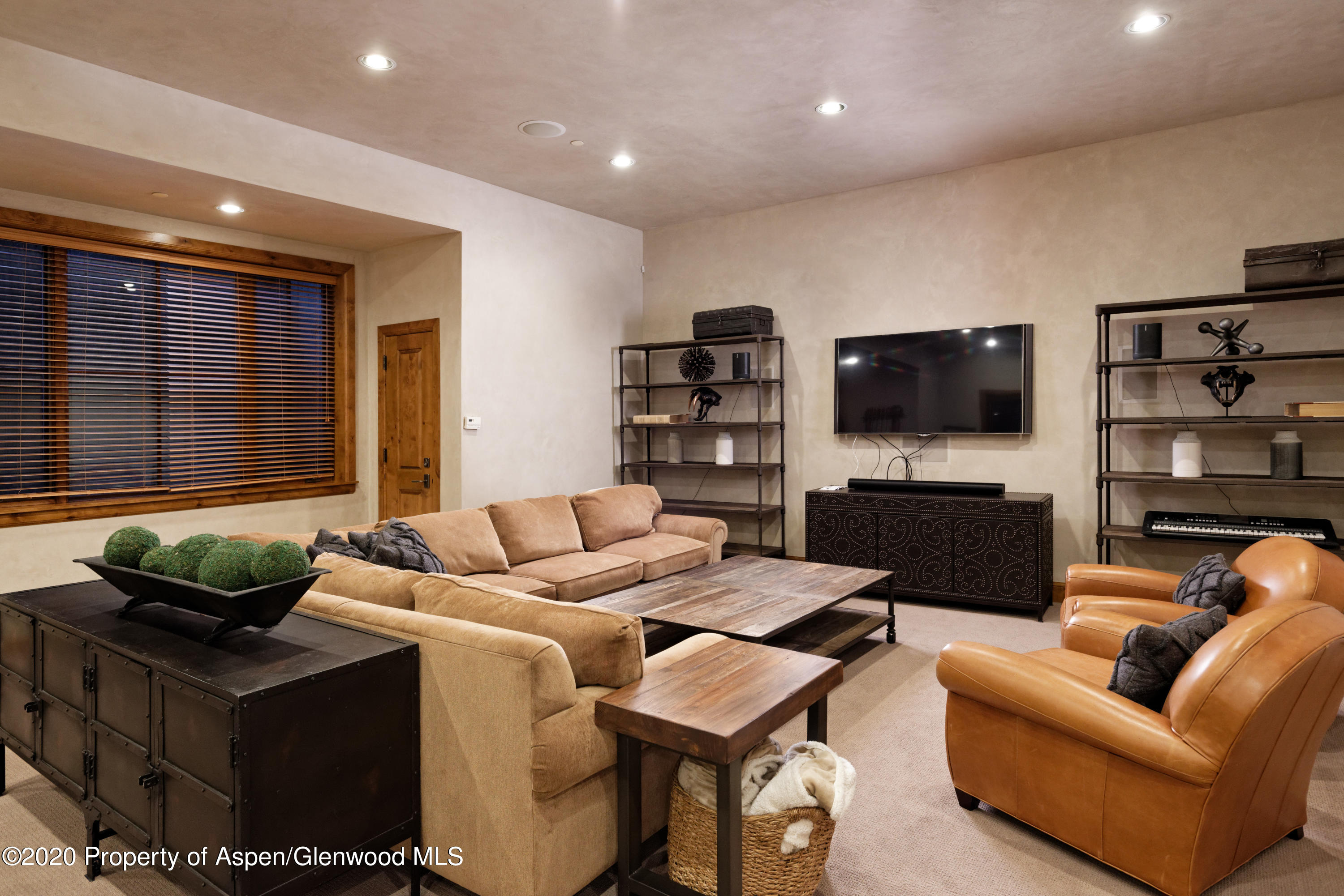 32 Prospector Road Aspen, CO 81611 - Photo 18 of 37 a living room with furniture and a flat screen tv