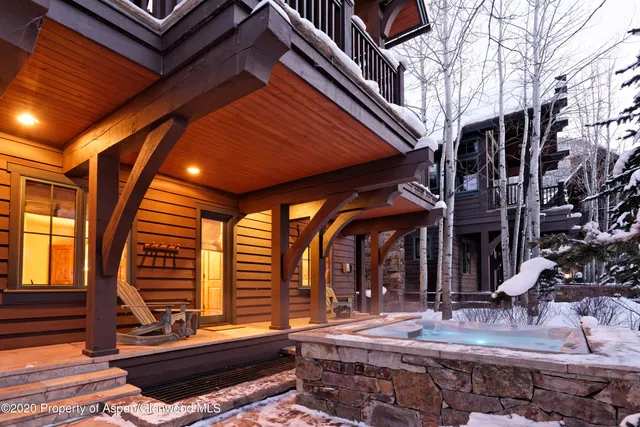 a backyard of a house with barbeque oven table and chairs