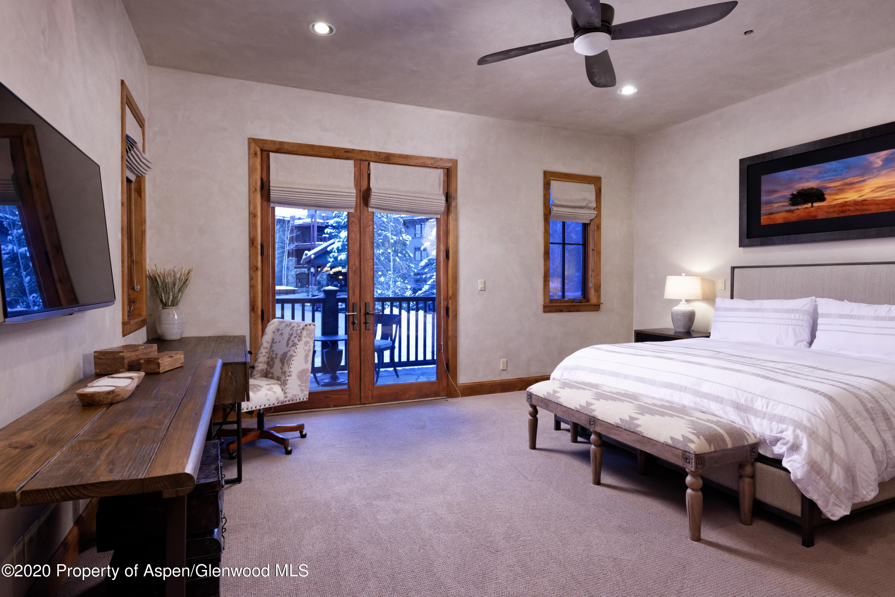 32 Prospector Road Aspen, CO 81611 - Photo 22 of 37 a bedroom with a bed and a flat screen tv